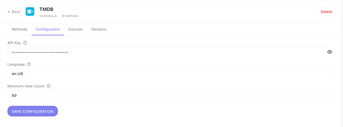 The TMDB extension's Configuration tab rendered from its configItems declaration: API Key as a masked field with a reveal icon, Language holding en-US, and Minimum Vote Count as a numeric field holding 50, above a Save Configuration button